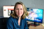 Headshot of Dr. Inge Molenaar in front of two computer screens. 